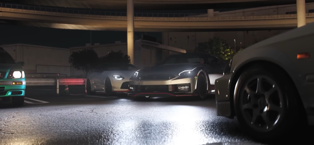 Forza Horizon 6 gameplay screenshot of a car in an urban night environment, highlighting atmospheric lighting, city detail, and reflective road surfaces.